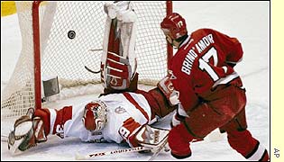 Detroit goaltender Dominik Hasek is beaten by Rod BrindAmour of Carolina