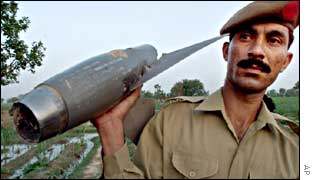Pakistani soldier holds up piece of spy plane wreckage