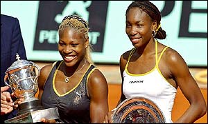 Serena Williams (right) and Venus Williams pose after the trophy ceremony at the French Open