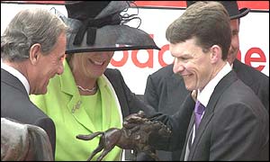 Aidan O'Brien receives the winner's trophy