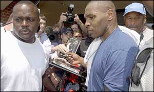 Mike Tyson is surrounded by fans as he leaves his gym