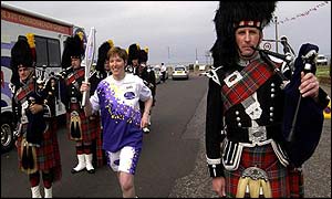 Baton carrier accompanied by a piper 