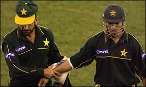 Imran Nazir is led off after being struck on the arm