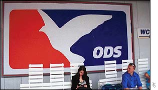 Two people sitting beneath an ODS poster