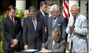 President Bush signing the bill at the White House