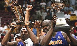Kobe Bryant (left) lifts the NBA championship trophy while Shaquille O'Neal shows off his 'most valuable player' prize
