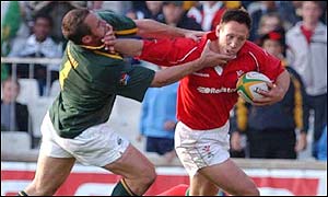 Wales centre Mark Taylor gets away from Daan Human