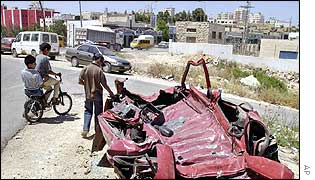 Palestinians inspect car crushed by tanks in Ramallah