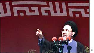 Khatami speech in front of Iranian flag and portrait of Khomeini