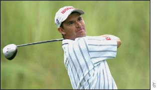 Padraig Harrington is three shots behind early leader Tiger Woods after his 70