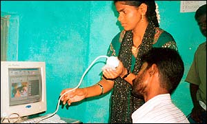 A patient uses the internet kiosk for his consultation with the eye surgeon 