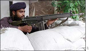Pakistani police officer guards a US mission