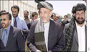 Hamid Karzai arriving at the Loya Jirga with aides