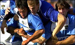 Gonzalo Longo is held back by France's Aurelien Rougerie