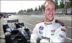 Cristiano da Matta poses with his car ahead of the Portland Grand Prix