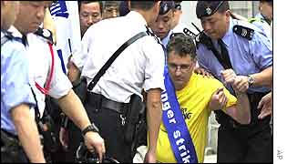Roland Isenschmid, a Swiss practitioner of Falun Gong, is seen in this file picture as he is taken away by police officers outside the Chinese government liaison office in Hong Kong on 16 March