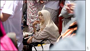 Malaysian woman at a bus stop