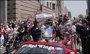 Wings coach Scotty Bowman holds the Stanley Cup aloft in Detroit.
