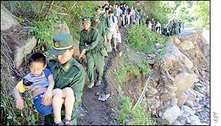 Chinese People's Liberation Army rescue team helps evacuate villagers in the outskirts of Xian