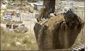 Bulldozer on the line where the wall will be