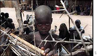 Boy waits at feeding centre during 1998 famine in southern Sudan