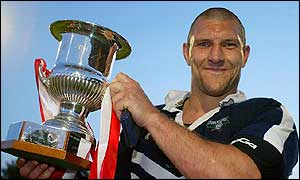 Barrie McDermott lifts the trophy after victory at Headingley