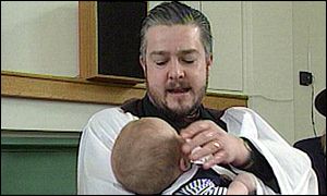 Vicar baptising a child
