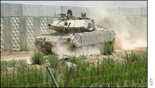 Israel tank patrolling a section of fence built years ago