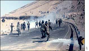 Police riot try to hold of protesters during a strike in Tacna, south-east of Lima