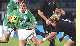 Ireland winger Justin Bishop swerves past Justin Marshall
