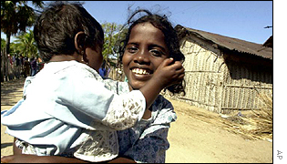 Tamil girl carrying a baby in Jaffna