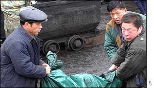 Rescue workers carry bodies of the victims at the Chengzihe Coal Mine in Jixi, north-east China 