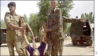Indian security forces carry body of dead militant