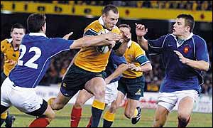 Stirling Mortlock (centre) takes on the French defence
