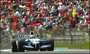 Juan Pablo Montoya passes a packed grandstand on his way to pole position at the Nurburgring
