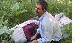 Man cries over a relative's body in the village of Changireh