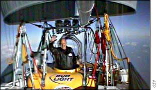 Balloonist Steve Fossett waves to a trailing plane