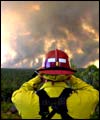 Firefighter Randy Chevalier watches the blaze