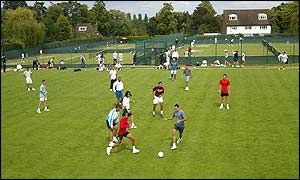 Tennis players play football  