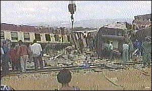 Rescue crews use a crane to search the wreckage