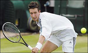 Alex Bogdanovic plays a backhand volley during his defeat by Nicolas Escude