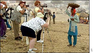 Tourists photograph Indian woman