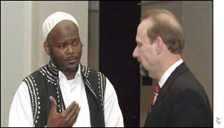 Abdul-Maalik Freeman, left, husband of Sultaana Freeman, talks with their attorney, Howard S. Marks