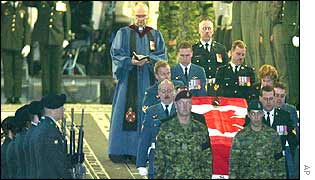 Pall bearers carry the coffin of one those killed after arrival at Ramstein airbase in Germany on 20 April, 2002