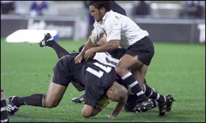 All Black Jonah Lomu is tackled by Nicky Little of Fiji 