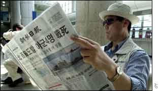 Man with South Korean newspaper