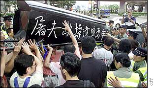 Hong Kong police stop human rights protesters from throwing a coffin over a barricade
