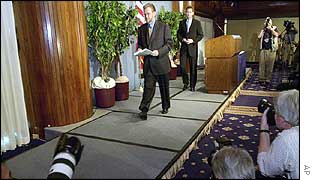 John Sidgmore leaves the stage after giving a press conference