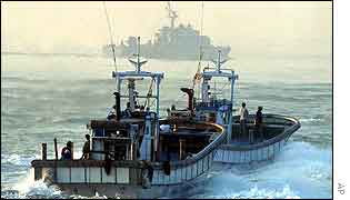 South Korean fishing-boats with patrol ship in background