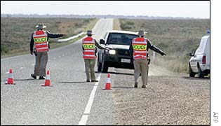 Police check cars at a road block about 15kms North of Port Augusta